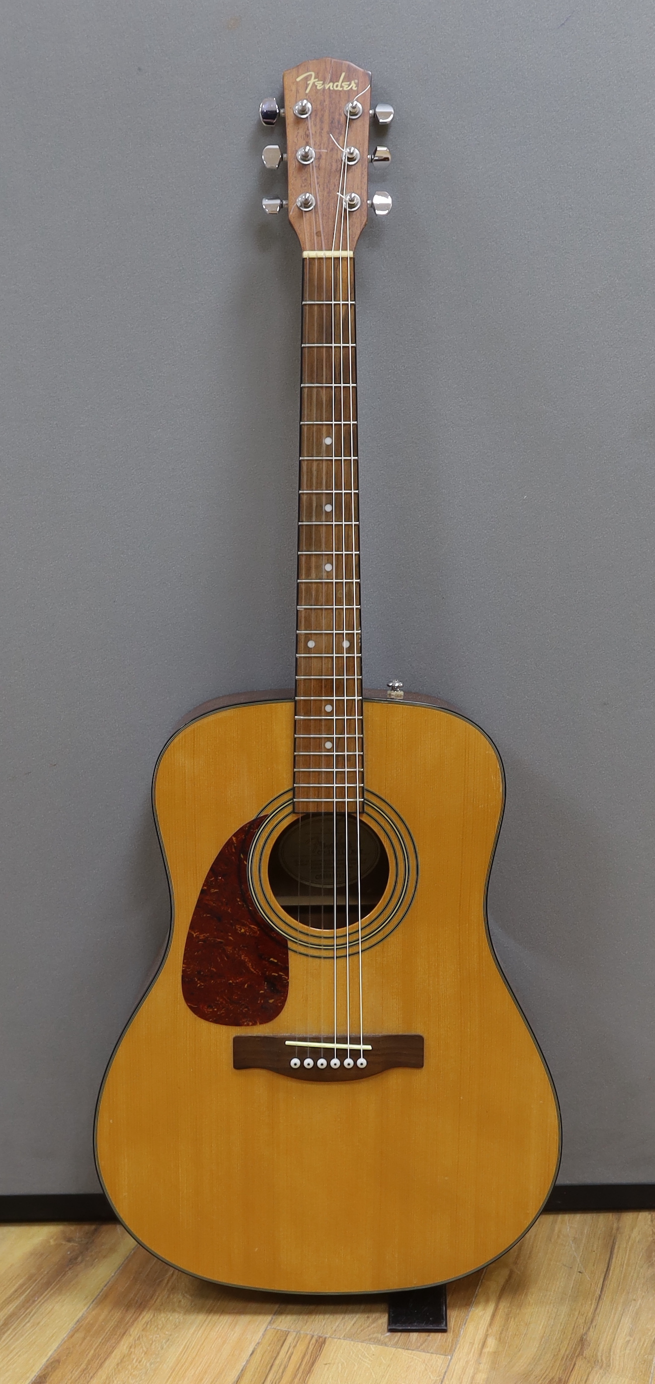 A Fender acoustic left handed guitar, in a hard case